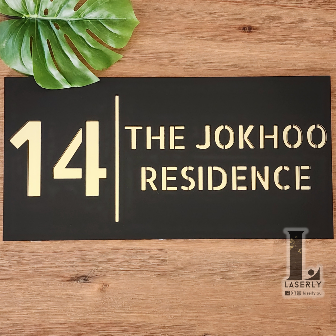 Modern acrylic house number sign mounted beside front door.