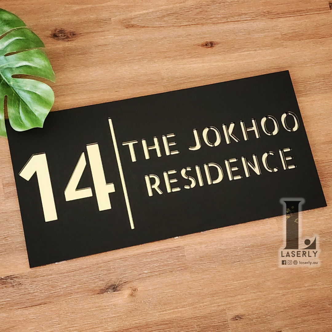 Minimalist acrylic house number sign with sleek glossy finish.
