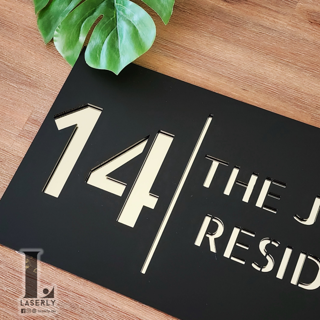 Elegant acrylic house number sign in natural daylight setting.