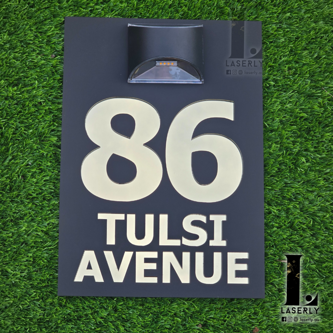 Contemporary house number sign made from acrylic with top-mounted solar light for clear night visibility.