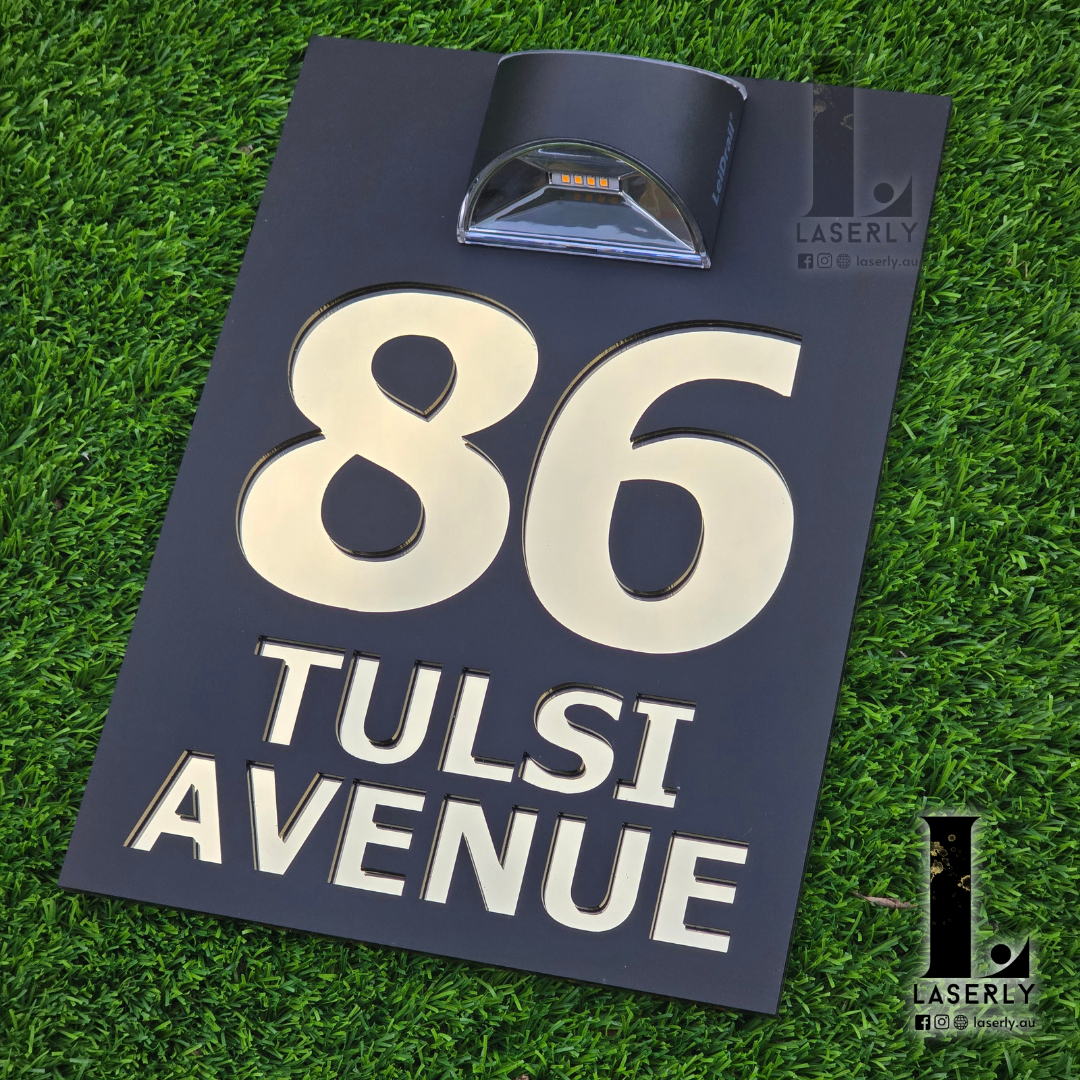 Contemporary house number sign made from acrylic with top-mounted solar light for clear night visibility.