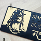 Acrylic gold and black Mahadev house number plaque with sleek mirror finish on exterior wall.