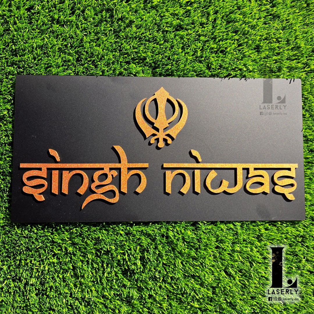 Front door view of a Kandha-inspired Ek-Onkar house number sign in black and bronze.
