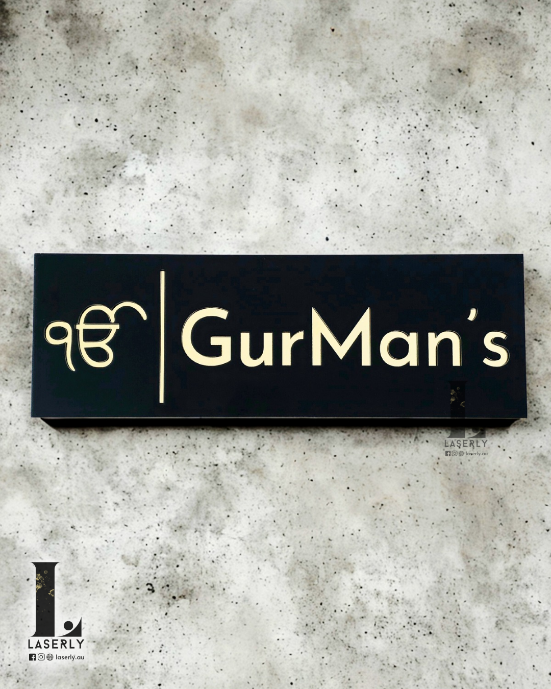 Modern Ek Onkar house number sign in black acrylic with mirror gold lettering mounted beside front door.