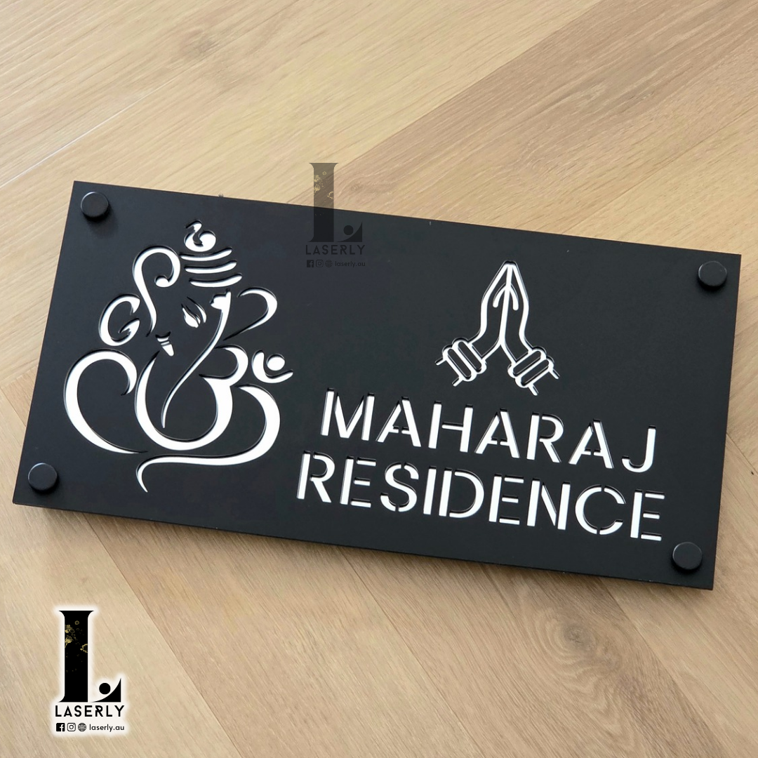 Laser-cut Ganesha Namaste house number plaque in matte black and reflective silver acrylic.