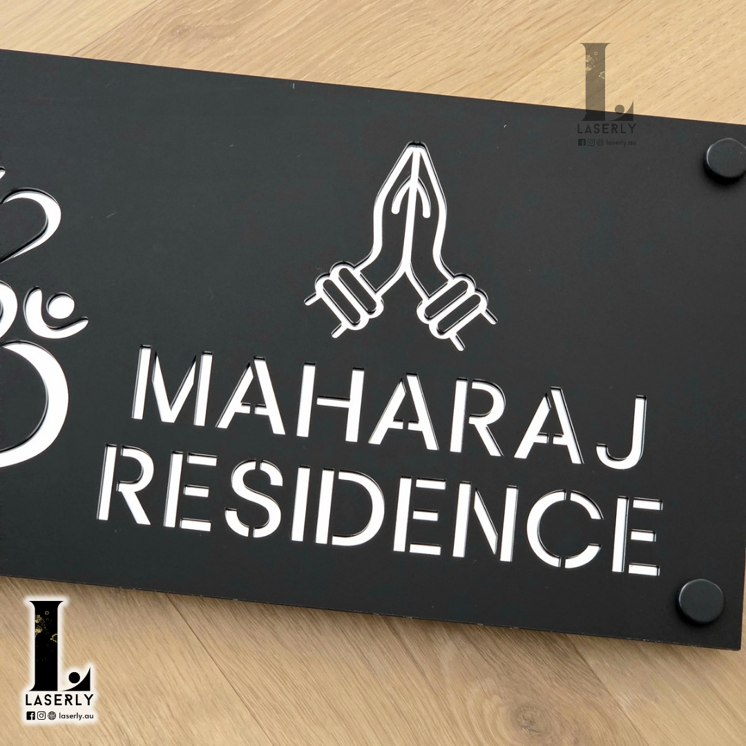 Elegant Ganesha Namaste house number sign with layered black base and mirror silver detailing.