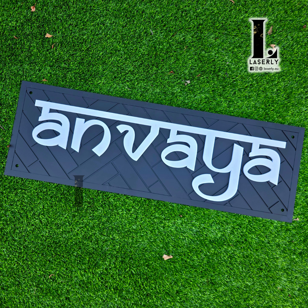 Elegant black patterned house name plaque displayed at home entrance.