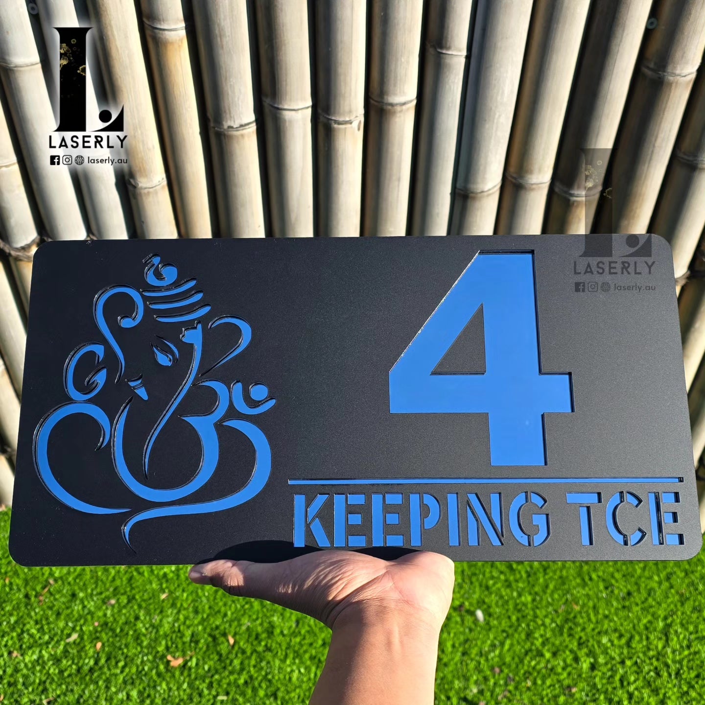 Front entrance view featuring black and silver Ganesha house number sign.