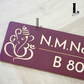Custom Ganesha house number sign in brown and gold mounted on facade wall.