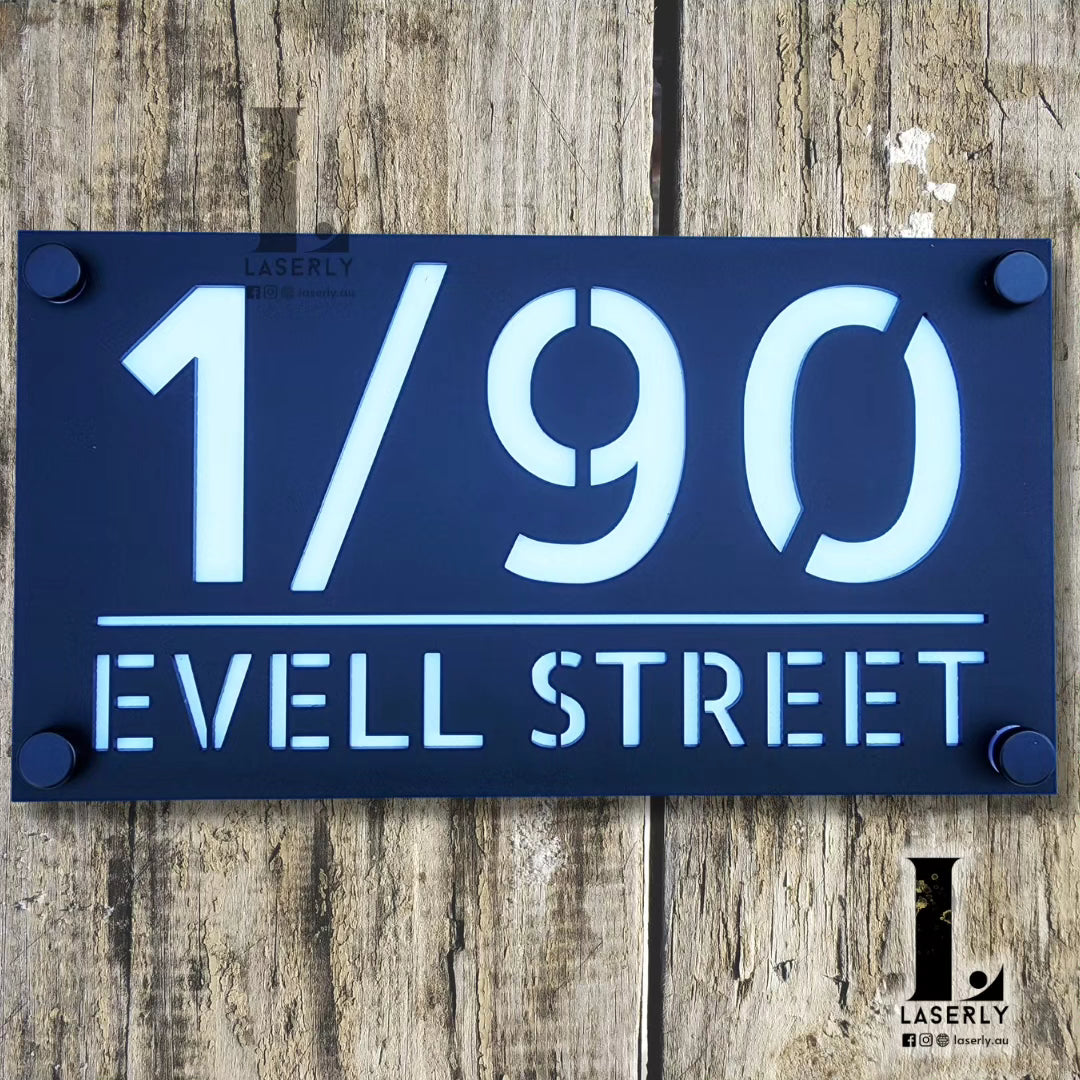 Minimalist acrylic house number plaque fixed near the main entryway.