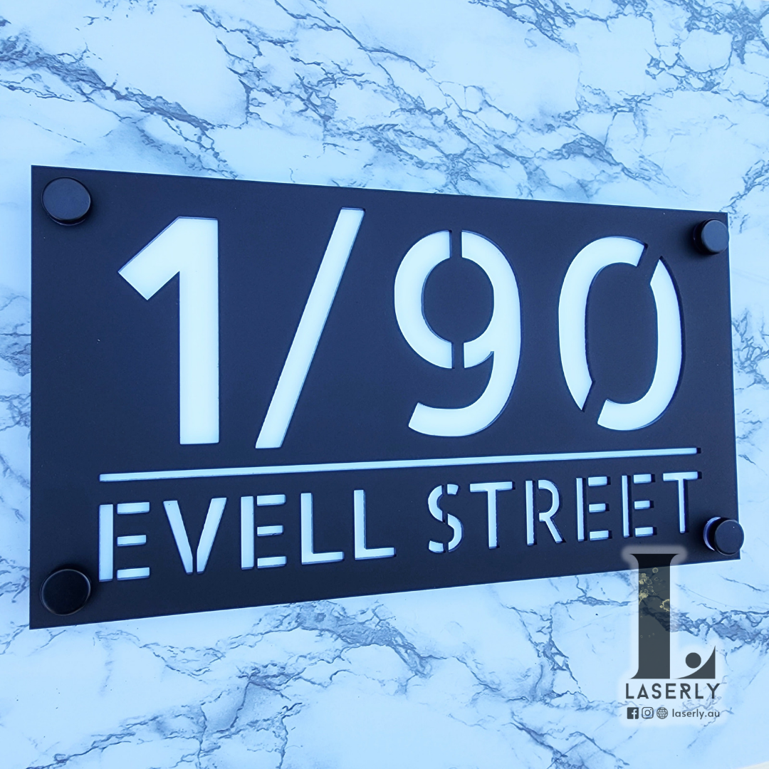 Contemporary house number sign in acrylic with sharp, modern finish.