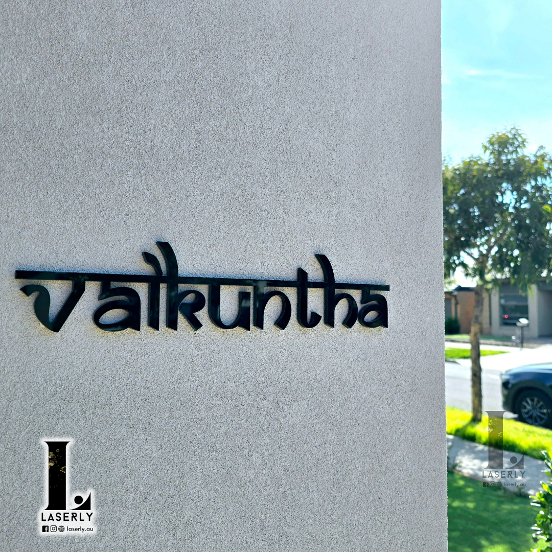 Elegant house name sign mounted beside a front door on a modern home exterior.