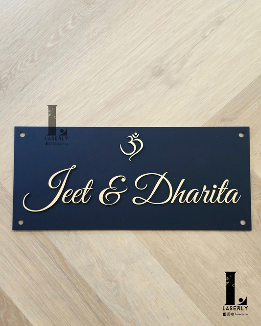 Elegant OM acrylic plaque displaying a home name beside the front door.