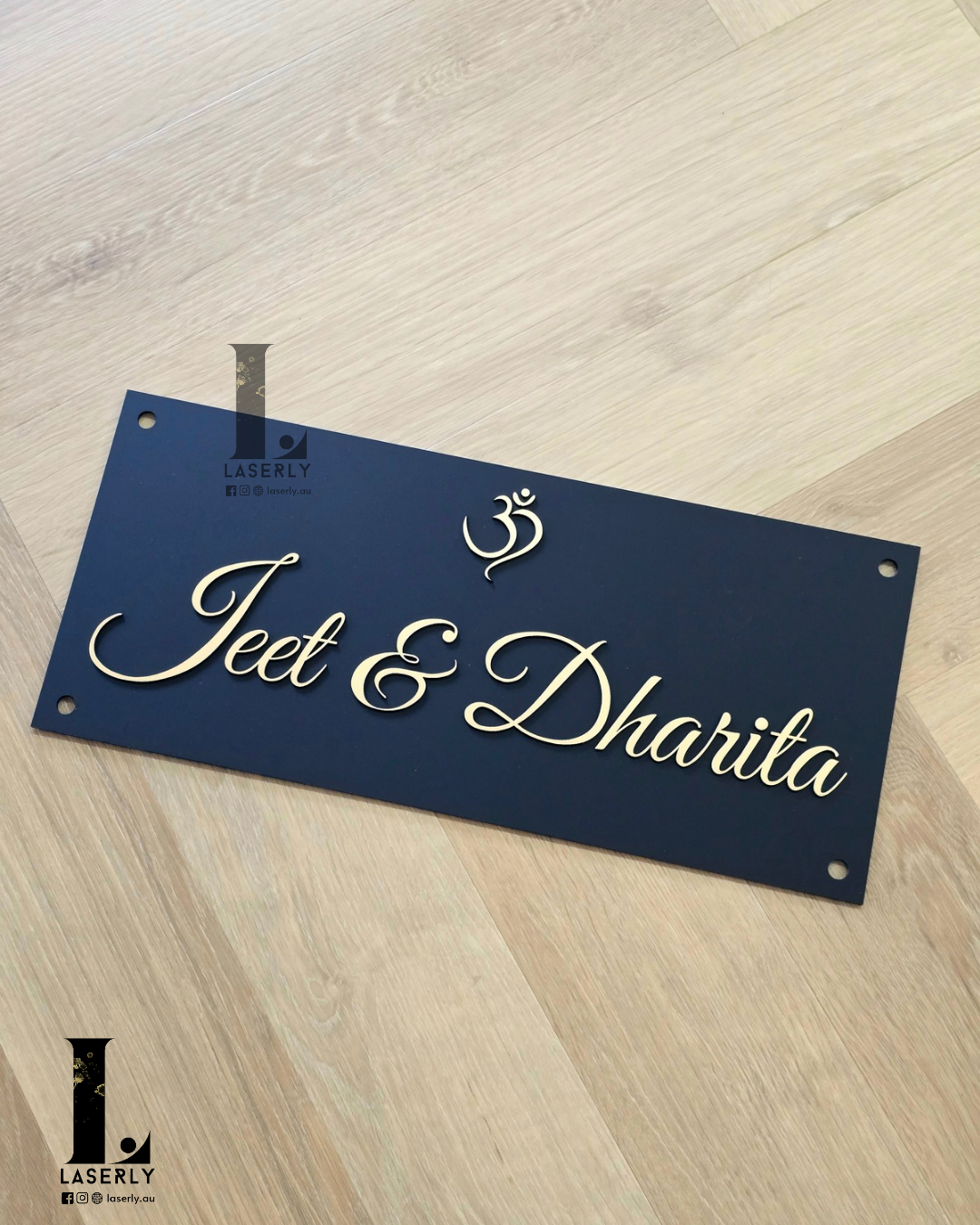 Modern house name sign featuring OM symbol in gold and black acrylic.