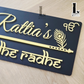 Contemporary black house number plate combining elegant flute design and symbolic evil eye charm.
