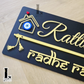 Stylish black wall-mounted house number plaque featuring flute-inspired design and evil eye embellishment.