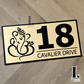 Decorative Ganesha house number plaque featuring intricate detailing on exterior wall.