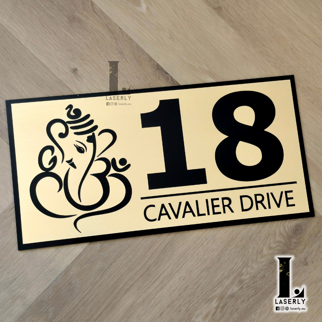 Decorative Ganesha house number plaque featuring intricate detailing on exterior wall.