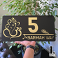 Contemporary home exterior with Ganesha-Krishna themed decorative number sign.