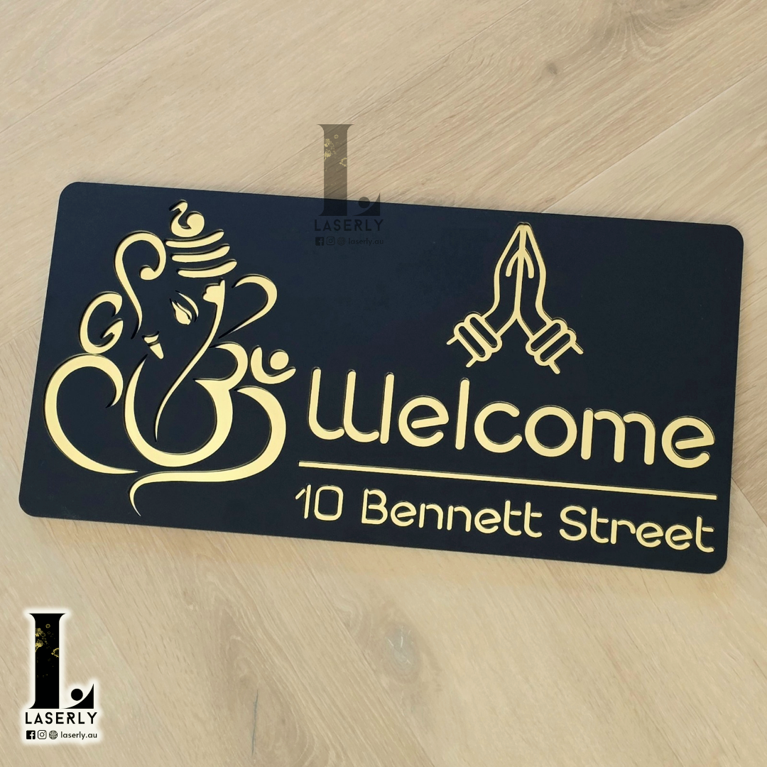 Modern Ganesha Namaste house number plaque with detailed laser-cut artwork displayed on exterior wall.