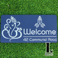 Laser-cut Ganesha Namaste home address sign with intricate detailing fixed on outdoor facade.