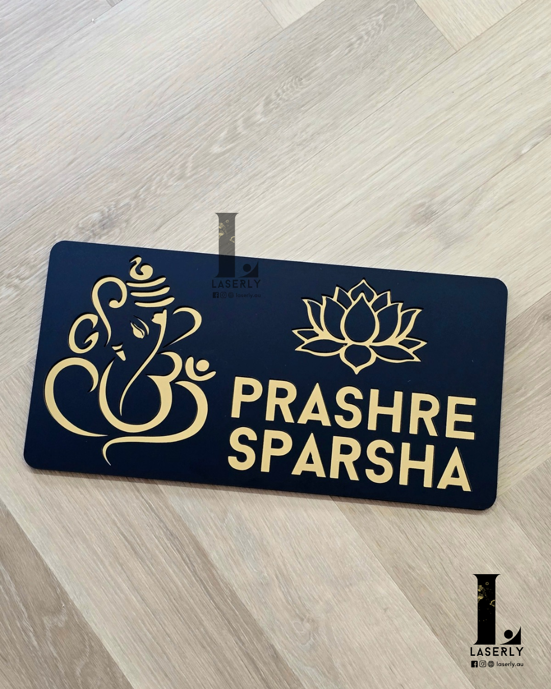 Modern acrylic house number sign featuring Ganesha and lotus design on exterior wall.