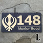Elegant Kandha house number plate in black and metallic gold finish for home entrance.