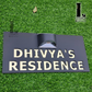 Horizontal house number sign with integrated solar light mounted beside a modern front door.