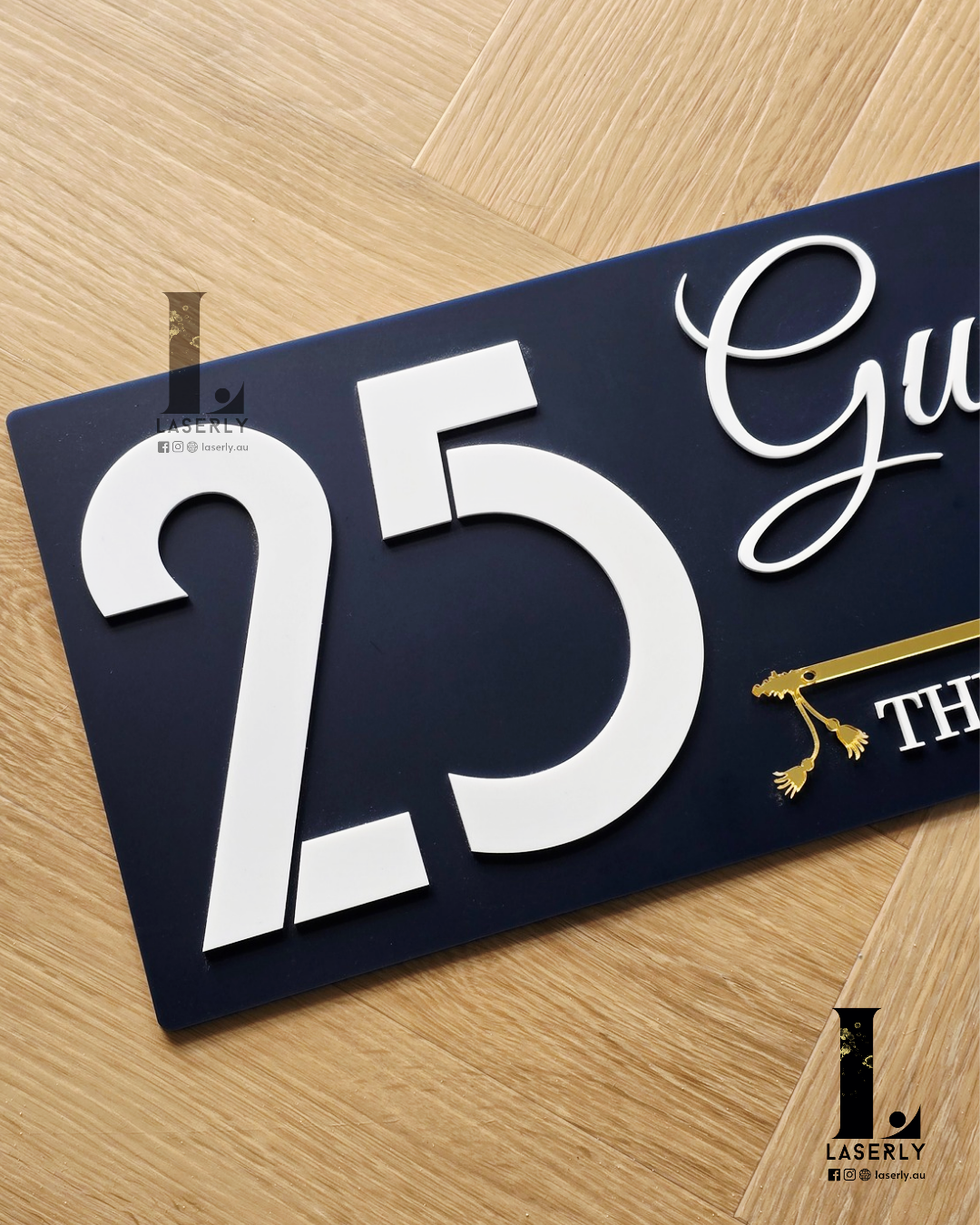 Contemporary navy blue acrylic house number sign showcasing evil eye charm and stylised flute design.