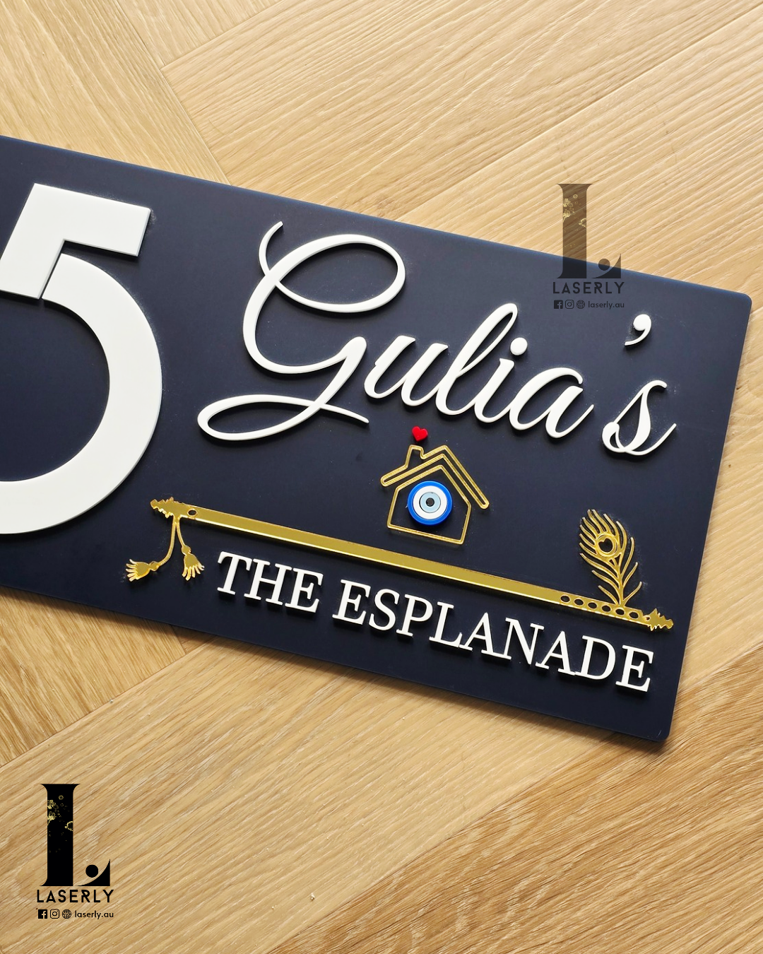 Luxury navy blue house number plaque with bold numerals, evil eye accent, and artistic flute detailing.