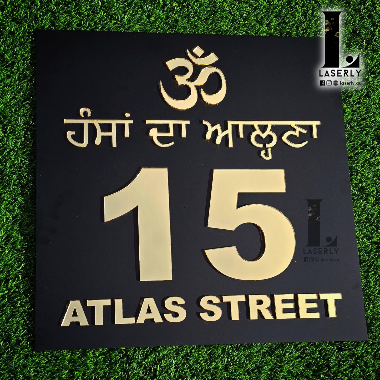 Personalized Punjabi-style OM number sign on a contemporary house wall.