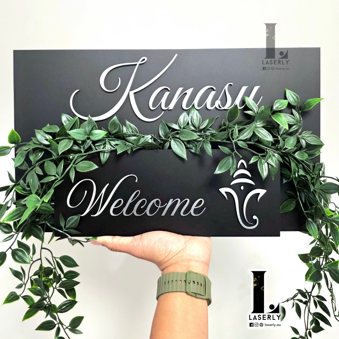 Modern silver planter with house number and decorative Ganesha, mounted outside home.