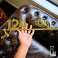 Custom house number sign inspired by Lord Krishna’s flute, perfect for home entrances.
