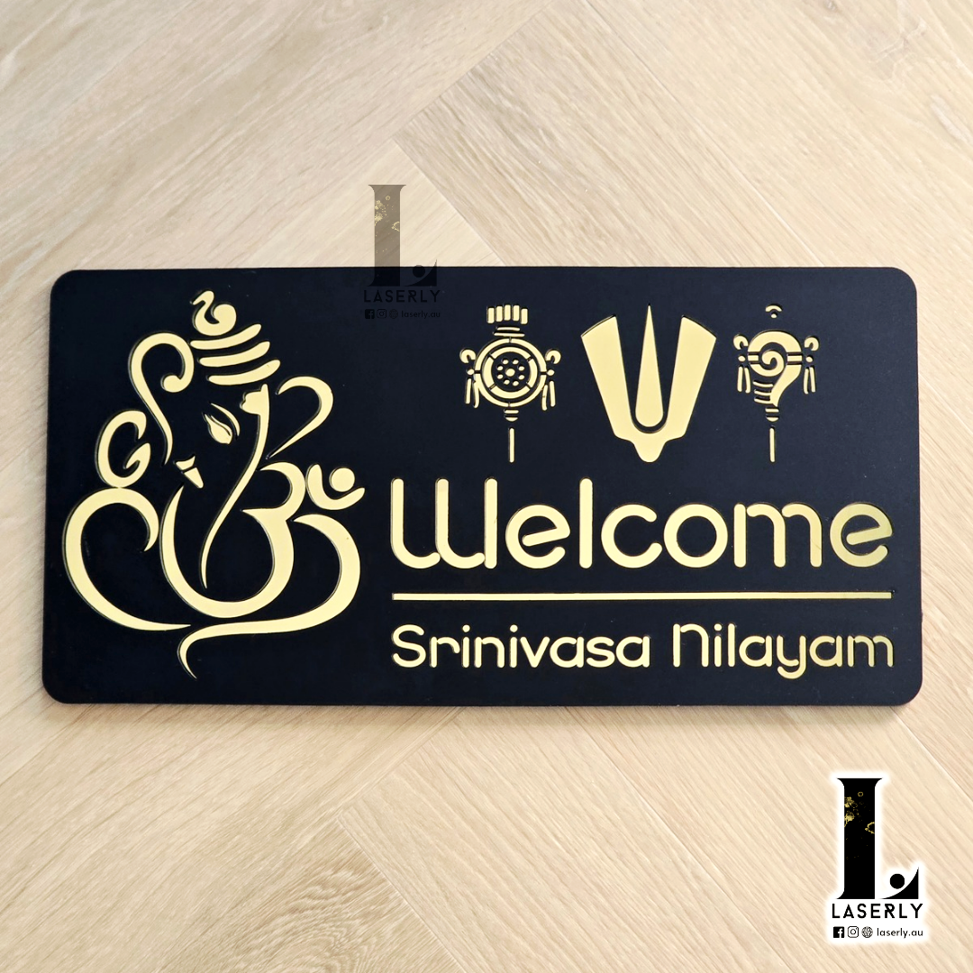 Srinivasa house number sign in laser-cut acrylic mounted beside a modern home entrance.