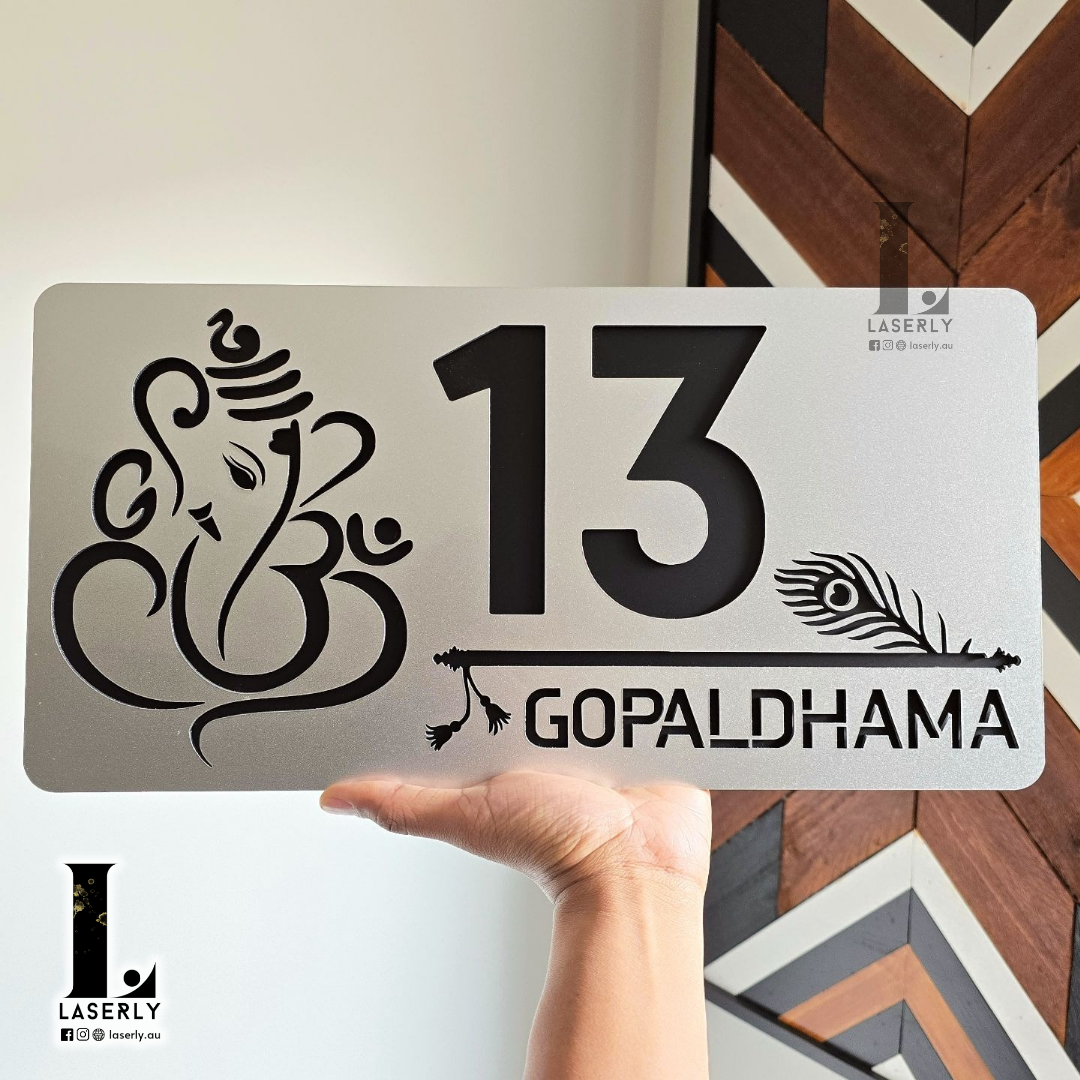 Modern house number sign with Ganesha and Krishna playing flute, steel-look acrylic design.