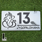 Acrylic house number with intricate Ganesha and Krishna flute motif, steel-finish style.