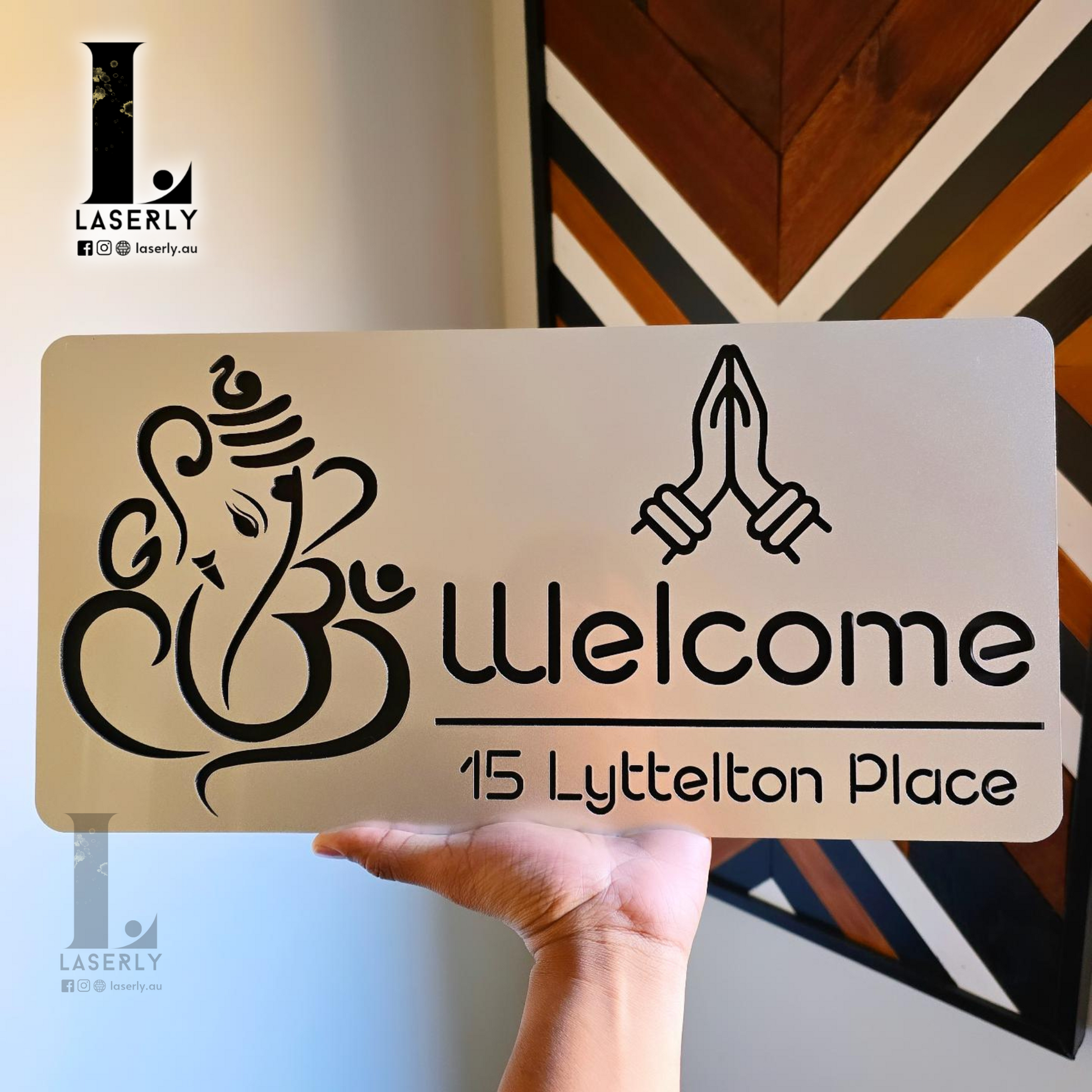 Close-up of laser-cut acrylic Ganesha house number sign with elegant metallic steel effect.