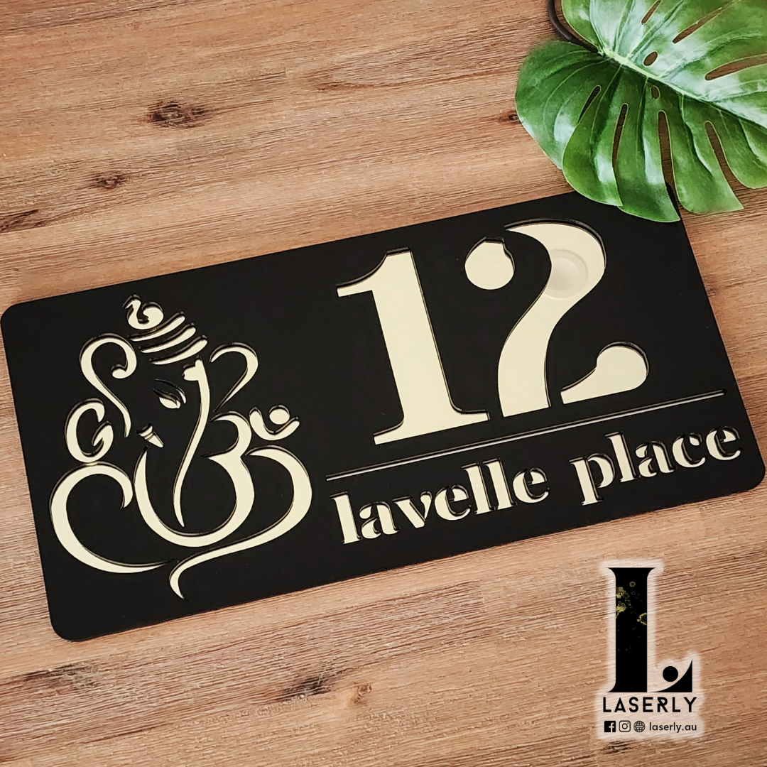 Modern Ganesha house number sign mounted beside the front door, featuring laser-cut acrylic design with elegant finish on exterior wall.