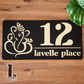 Decorative Ganesha house number plaque installed near entrance door, crafted in premium acrylic with detailed laser-cut spiritual design.