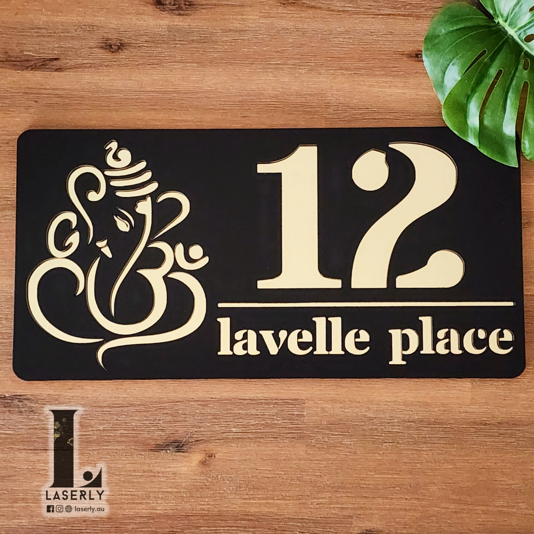 Decorative Ganesha house number plaque installed near entrance door, crafted in premium acrylic with detailed laser-cut spiritual design.