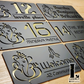 Laser-cut Ganesha house number sign mounted beside a modern front door with elegant acrylic finish.